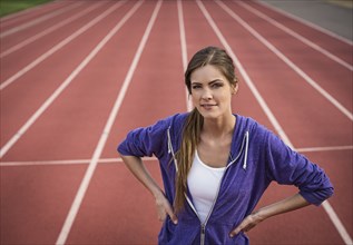 Caucasian woman posing on running track