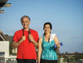 Portrait of older couple resting outdoors after workout