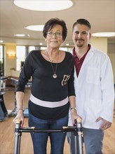 Portrait of Caucasian physical therapist patient with walker