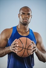 Confident black man holding basketball
