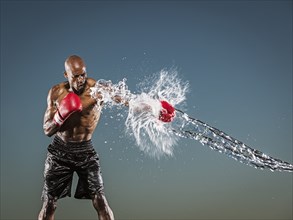 Water splashing on black boxer punching