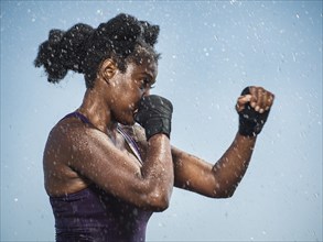 Water splashing on sparring Black woman