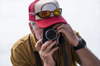 Caucasian man photographing with camera
