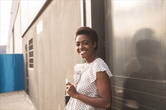 Smiling African American woman holding cell phone