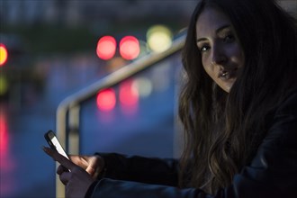 Portrait of Caucasian woman texting on cell phone outdoors