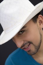 Hispanic man in white fedora hat