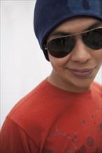 Hispanic man in cap and sunglasses