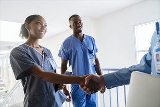 Doctor and nurse shaking hands