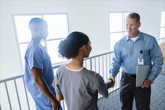 Doctor and nurse shaking hands