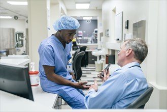 Doctor and nurse discussing cell phone