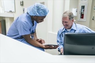 Doctor and nurse discussing digital tablet