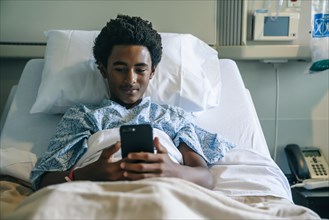 Blackboard texting on cell phone in hospital bed