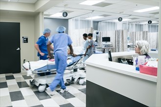 Nurses pushing hospital gurney