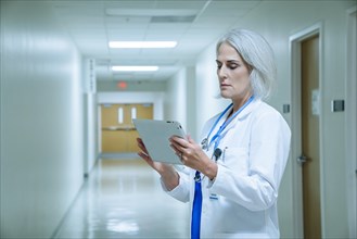 Caucasian doctor using digital tablet in hospital