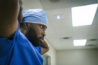 Black doctor wearing surgical cap