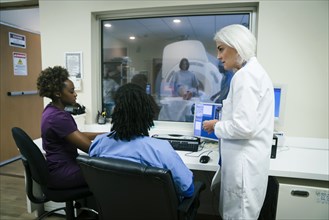 Doctor talking to nurses near scanner