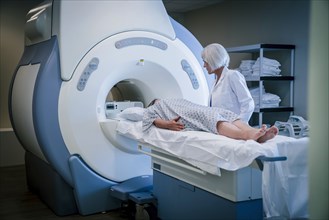 Doctor talking to patient at scanner