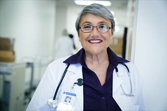 Portrait of smiling mixed race doctor