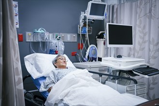 Mixed race patient in hospital bed