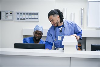Nurses using computer in hospital