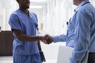 Close up of doctor and nurse shaking hands
