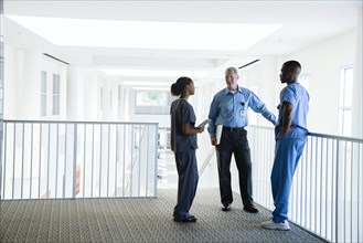 Doctor and nurses talking near staircase