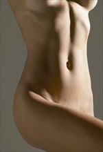 Close up of nude Hispanic woman's torso