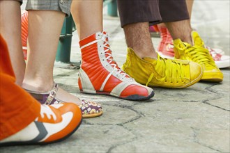 Close up of group of young people's feet with funky shoes