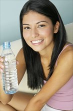 Hispanic woman holding water bottle