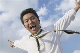 Asian businessman with arms outstretched