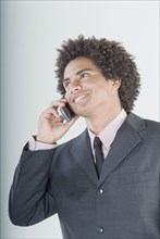 Mixed Race businessman talking on cell phone