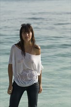 Young woman wearing wet shirt at beach