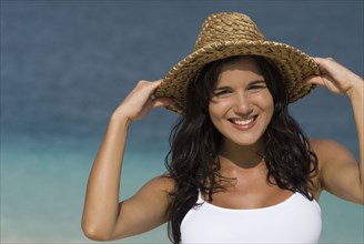 Hispanic woman wearing straw hat