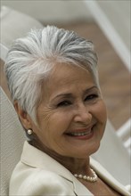 Senior Hispanic woman in lounge chair