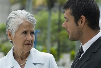 Hispanic mother and adult son talking