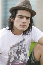 Young Hispanic man wearing hat