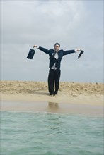Hispanic businessman at beach