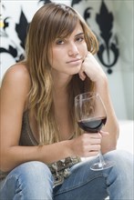 Portrait of Hispanic woman holding wine glass