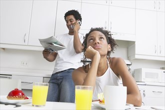 Frustrated African woman in kitchen with boyfriend