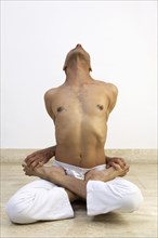 Man practicing yoga indoors
