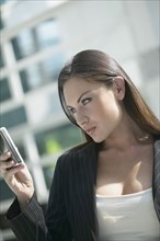 Italian businesswoman looking at cell phone