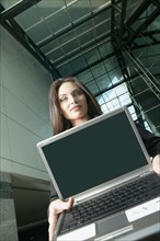 Italian businesswoman holding laptop