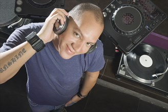 Hispanic DJ performing in nightclub