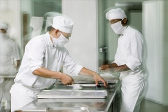 Baker's working in bakery kitchen