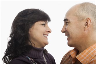 Hispanic couple smiling at one another