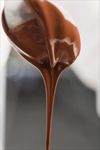Chocolate dripping from spoon