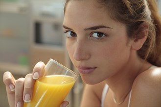 Caucasian woman drinking orange juice