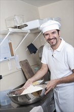 Hispanic baker working in commercial kitchen