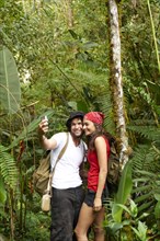 Hispanic couple talking self-portrait in forest