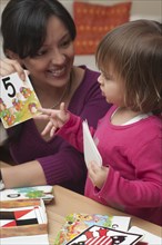 Hispanic mother teaching daughter numbers